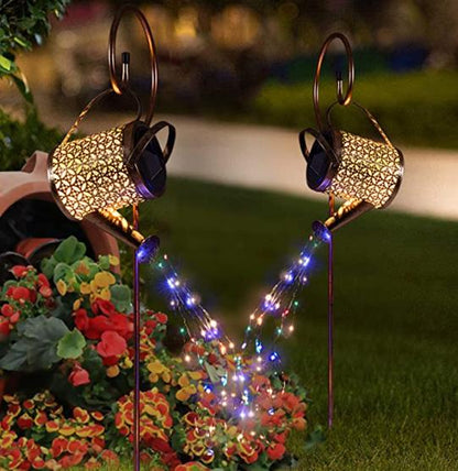 Solar watering can light — a copper hanging lantern with a pierced pattern and multicolour fairy lights from the spout