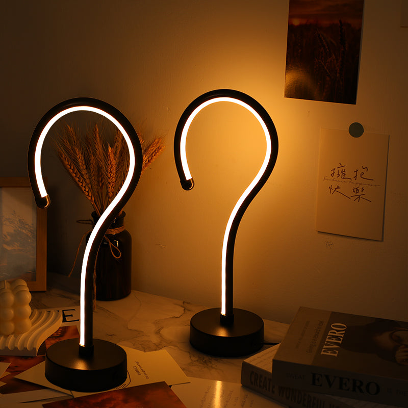 Quill question mark shaped table lamps with curved acrylic light tubes on weighted black bases, shown as a pair
