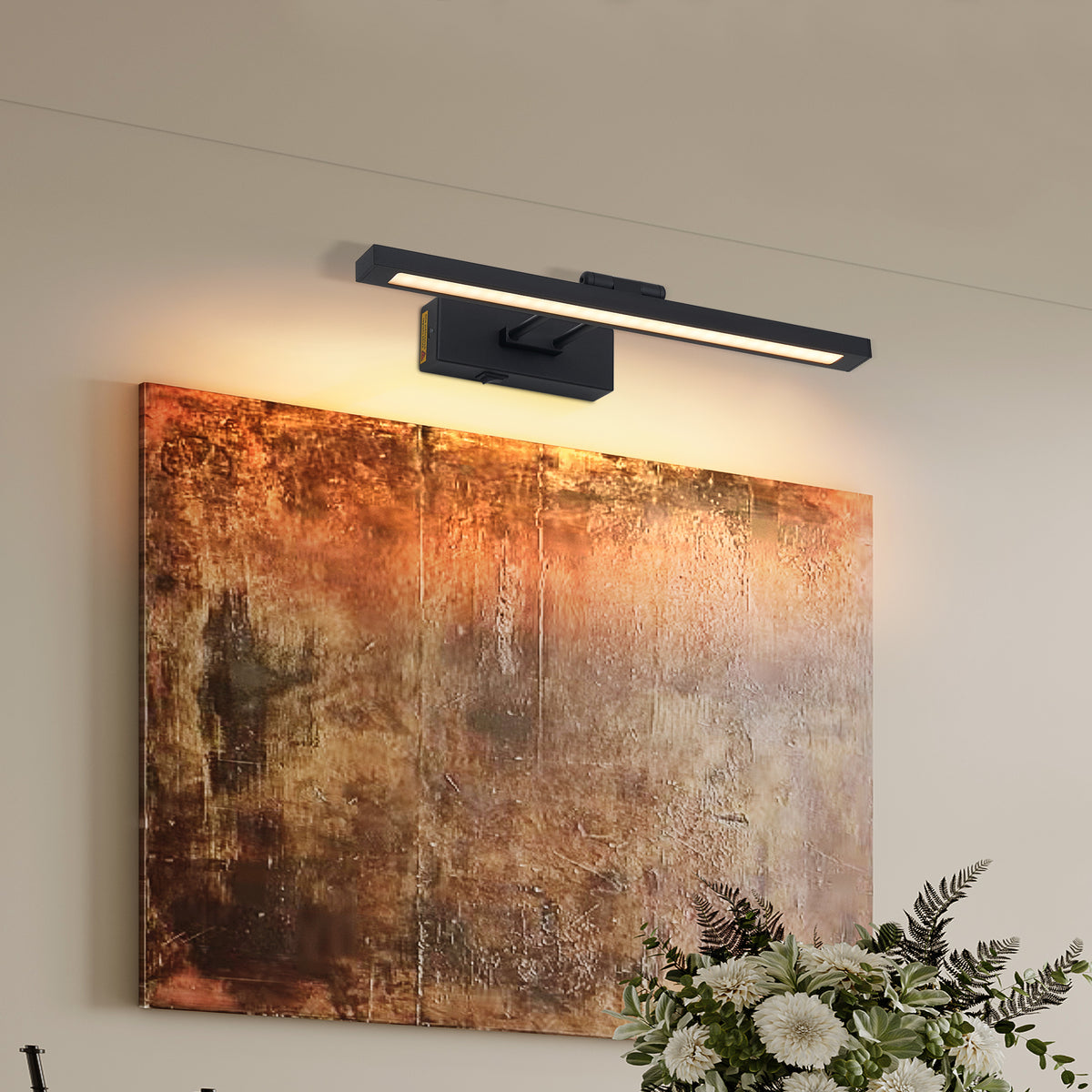 Calloway battery-operated picture light in black with adjustable swing arm, mounted above a framed painting