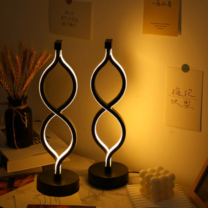 Wave LED table lamp — a slim acrylic ribbon of light on a round weighted base, USB powered