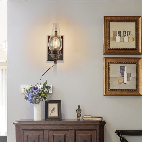 Aldridge plug-in wall sconce, clear glass chimney shade on a hand-painted black and gold base, alternate view