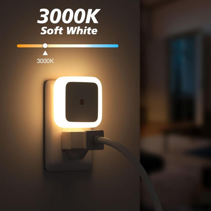 White plug-in dusk to dawn LED night light in a wall outlet, alternate view 3