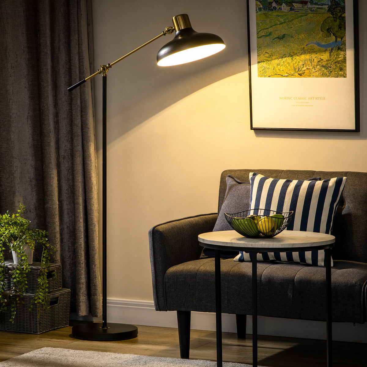 Thornton balance arm floor lamp in black and gold with an adjustable arm and dome shade beside an armchair