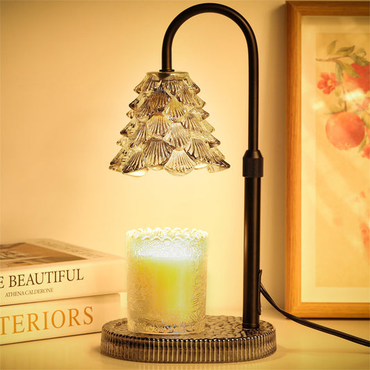 Candle warmer lamp with a transparent glass tree shade on a gold metal stand, warming a jar candle from above