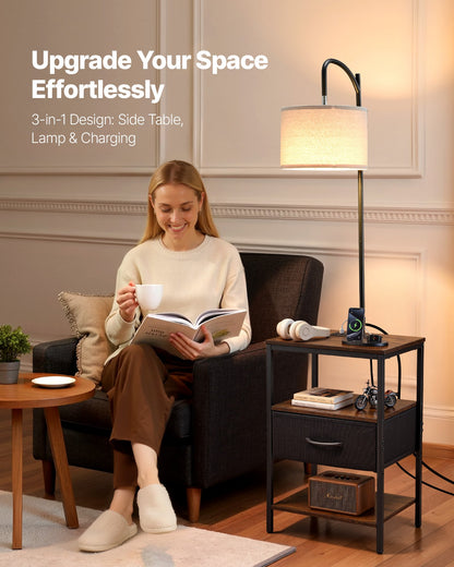 Floor lamp with side table shown in a living room beside an armchair, lamp lit above the tabletop