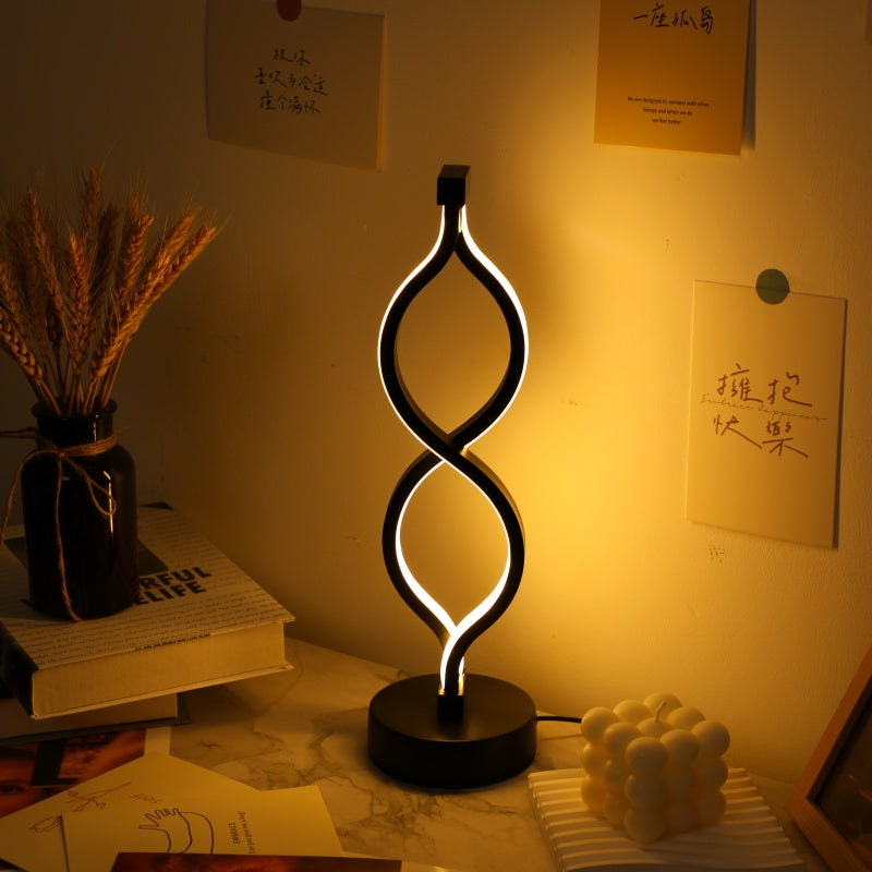 Wave LED table lamp, acrylic ribbon of light on a round base, alternate view 1