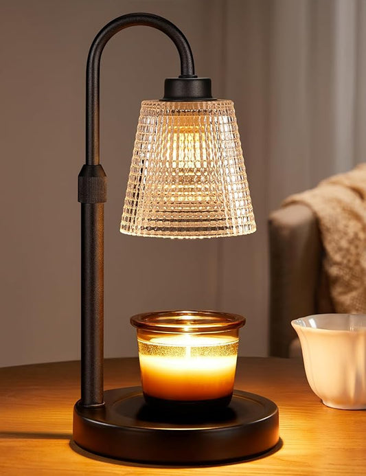 Candle warmer lamp with a ribbed glass shade on a matte black stand, warming a jar candle from above