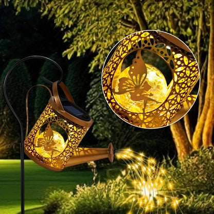 Solar watering can lantern — a bronze metal can on a shepherd's hook with warm fairy lights pouring from the spout