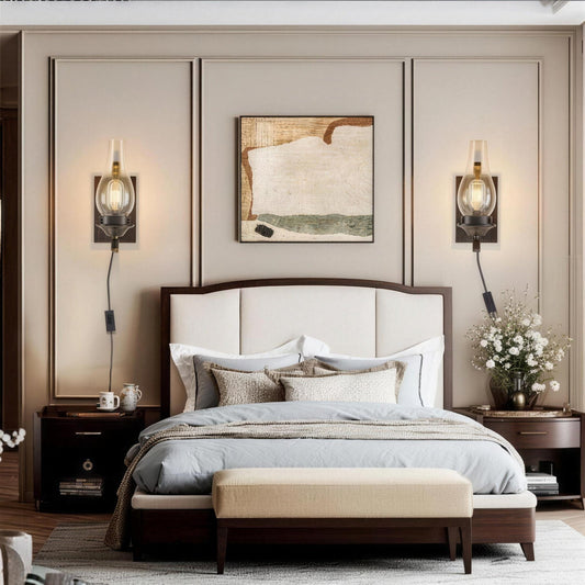 Plug-in wall sconce, clear glass chimney shade on a hand-painted black and gold base, sold as a set of two
